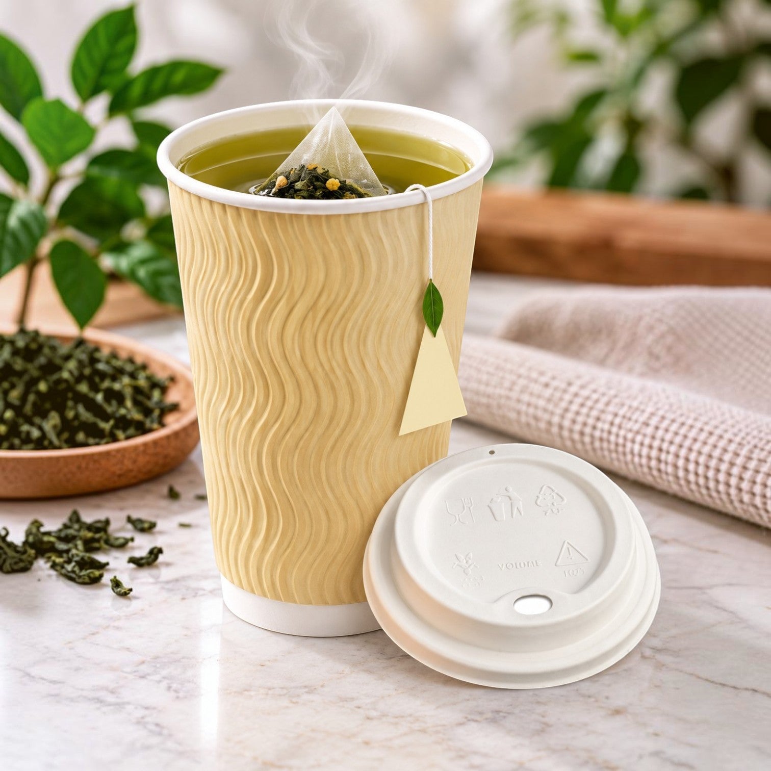 Eco Disposable Tableware beige textured paper cup with tea bag and white lid on a marble surface