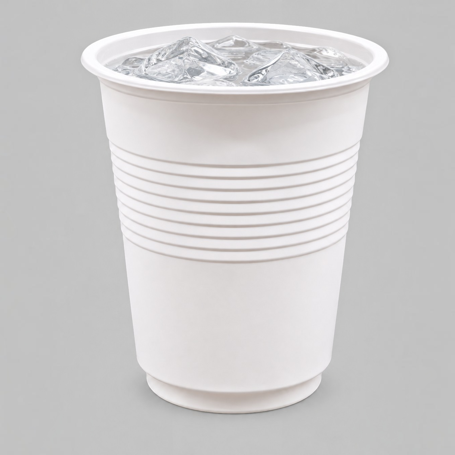 Eco Disposable Tableware white compostable cold cup filled with ice cubes on a grey background